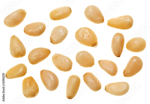 Unshelled pine nuts isolated on white, food background