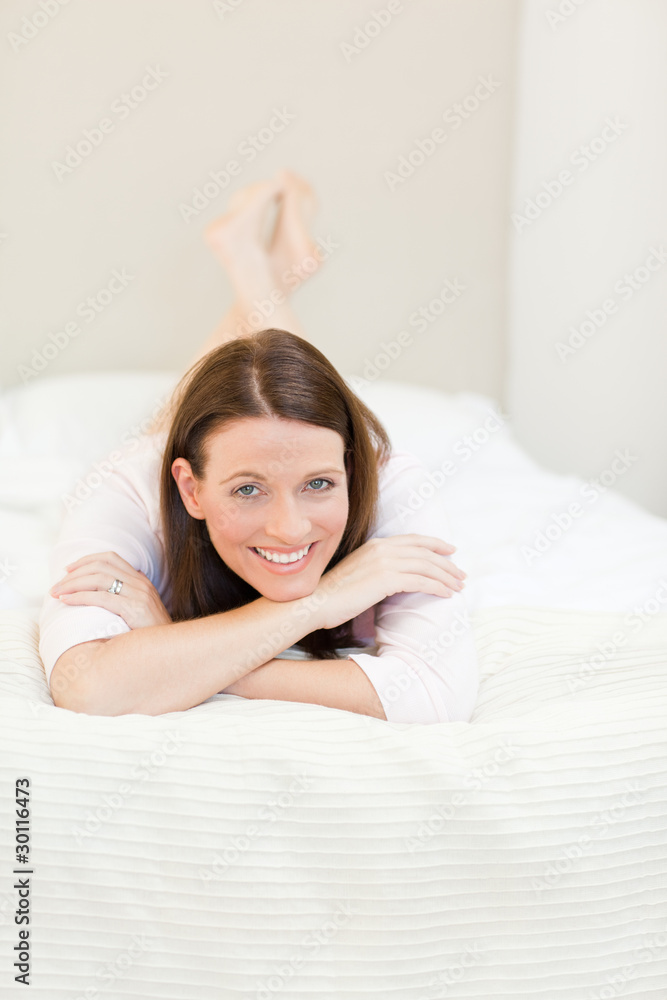 Pretty woman lying down on her bed Pretty woman lying down on her bed