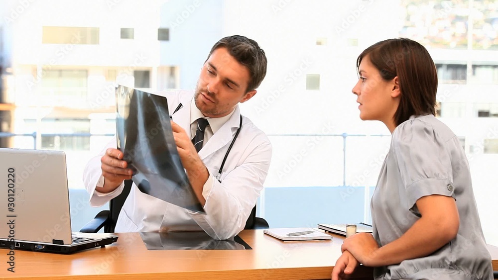 Doctor and his patient talking about a scan Doctor and his patient talking about a scan