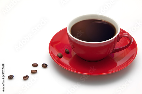 Red coffee cup and grain on white background