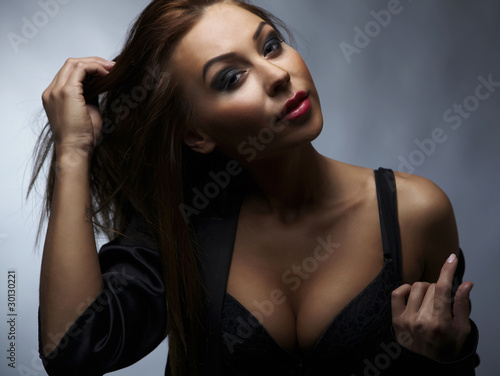 Sexy woman posing over dark background.