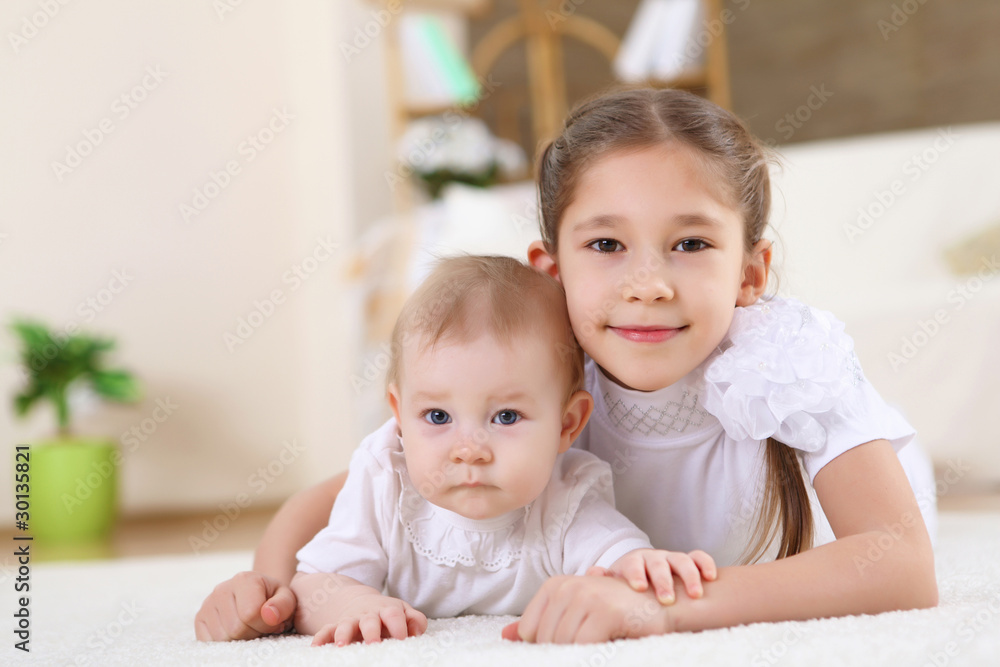 two little sisters together at home two little sisters together at home