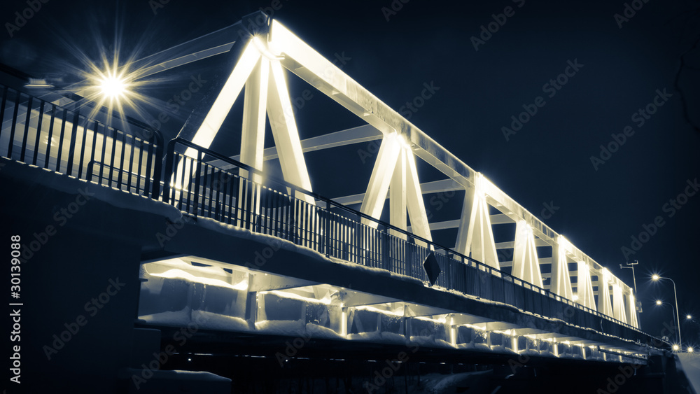 Illuminated bridge at night in winter