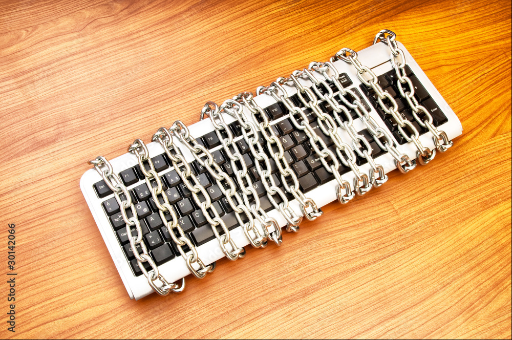 Computer security concept with keyboard and chain