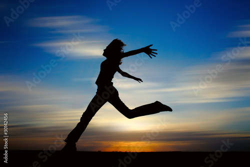 Wallpaper Mural Young woman jumping with raised hands Torontodigital.ca