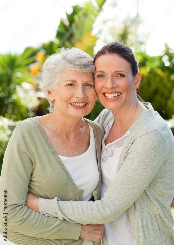 Obraz premium Mother with her daughter looking at the camera in the garden