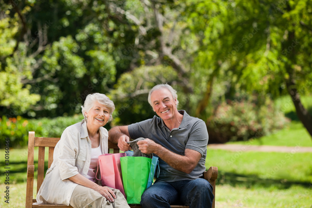 Retired couple with shopping bags