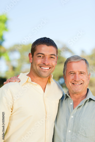 Father with his son looking at the camera in the park
