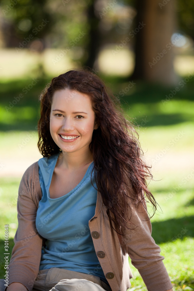 Lovely woman sitting in the garden