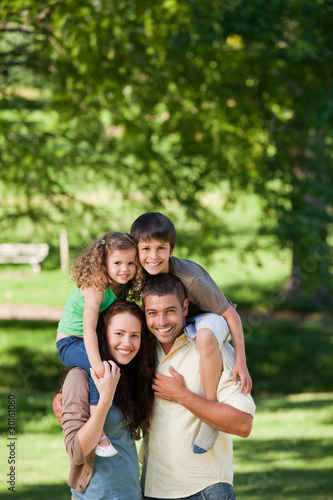 Parents giving children a piggyback