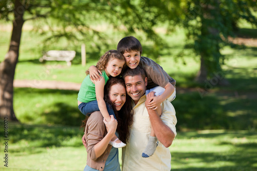 Parents giving children a piggyback