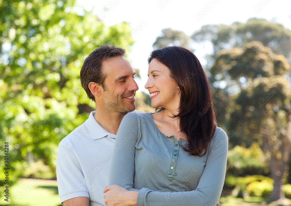 Beautiful couple hugging in the park Beautiful couple hugging in the park