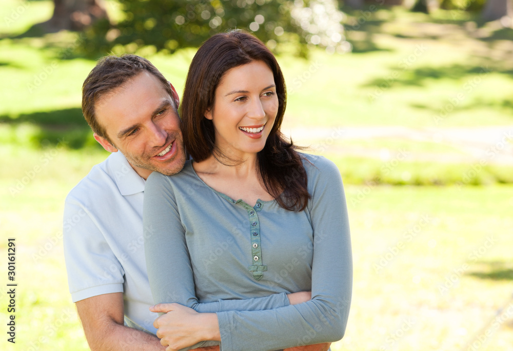 Fototapeta premium Beautiful couple hugging in the park