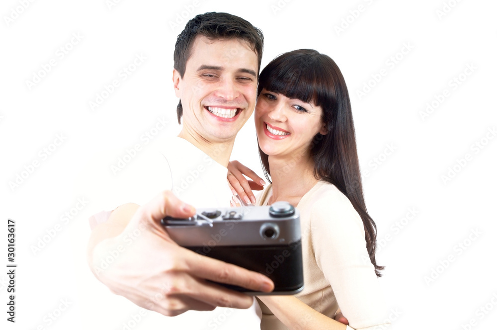 Young beauty couple with photo camera isolated on white backgrou Young beauty couple with photo camera isolated on white backgrou