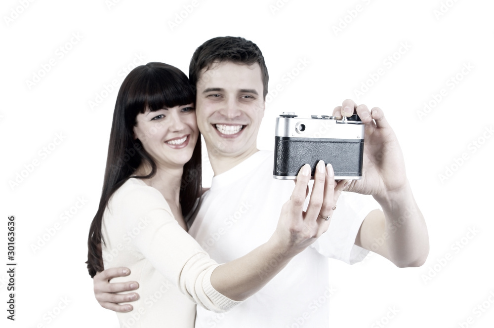 Young beauty couple with photo camera isolated on white backgrou Young beauty couple with photo camera isolated on white backgrou