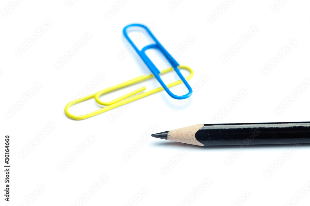 black pencil and colored paper clip isolated on white black pencil and colored paper clip isolated on white