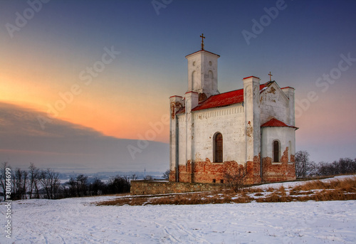 A photo of a catholic church in wintertime photo