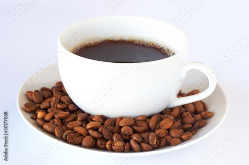 Cup of fresh coffee with roast beans