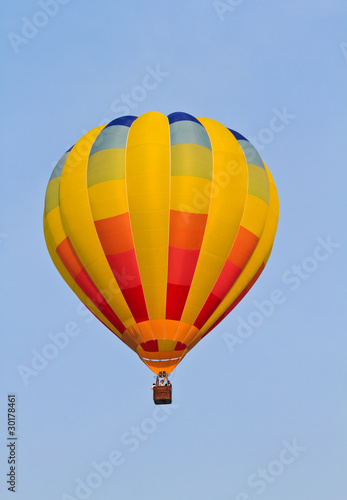 Colorful hot air balloon in blue sky .