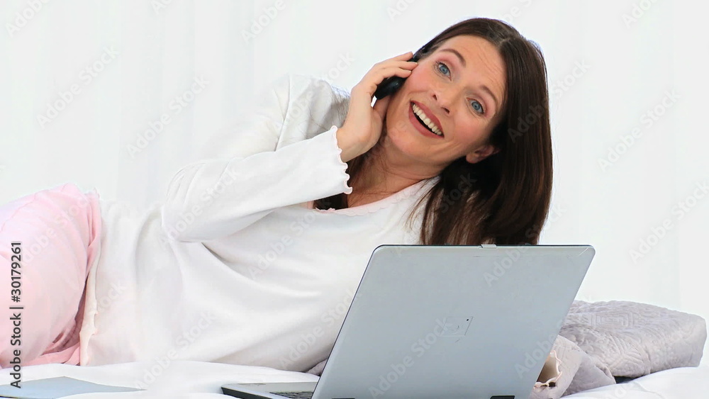 Brunette woman speaking on the phone Brunette woman speaking on the phone