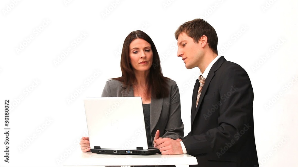 Business people speaking in front of a laptop Business people speaking in front of a laptop