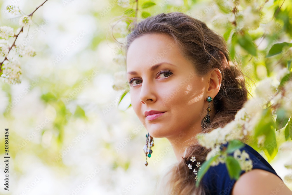 Beautiful woman among blossoming trees Beautiful woman among blossoming trees