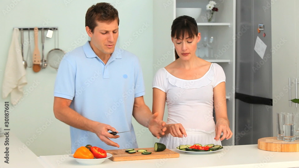 Cute couple cooking together in the kitchen Cute couple cooking together in the kitchen