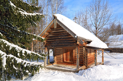 wooden chapel in winter village © Sergey YAkovlev