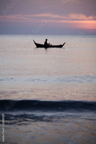 Smal thai fisherboat silhouetted