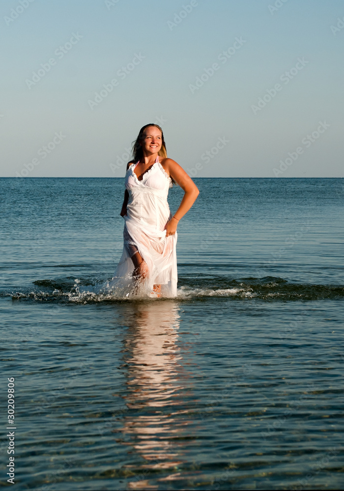 beautiful young girl running on sea beautiful young girl running on sea