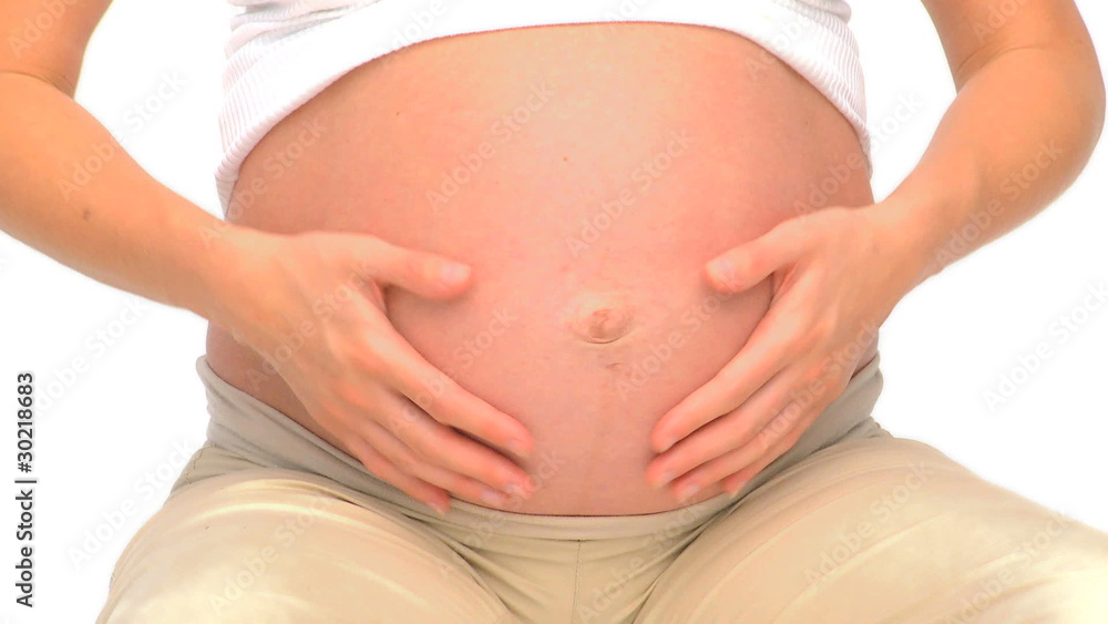 Pregnant woman doing exercise on a gym ball Pregnant woman doing exercise on a gym ball