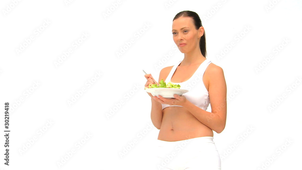 Woman in sportswaer eating a salad