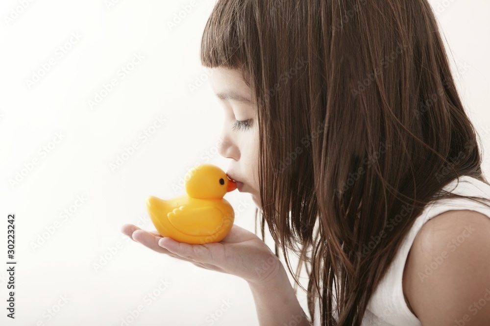 little toddler girl kissing a yellow bath duck little toddler girl kissing a yellow bath duck