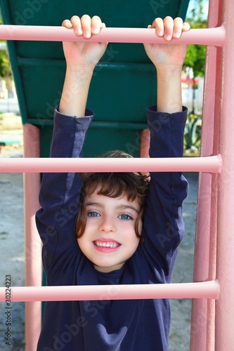 little girl climbing pink stairs of slide © lunamarina