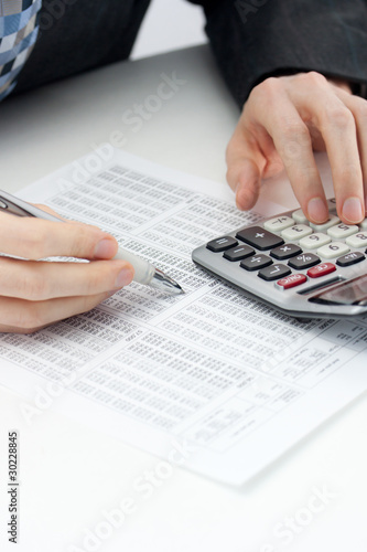 Calculating expenses, taxes and banking accounts photo