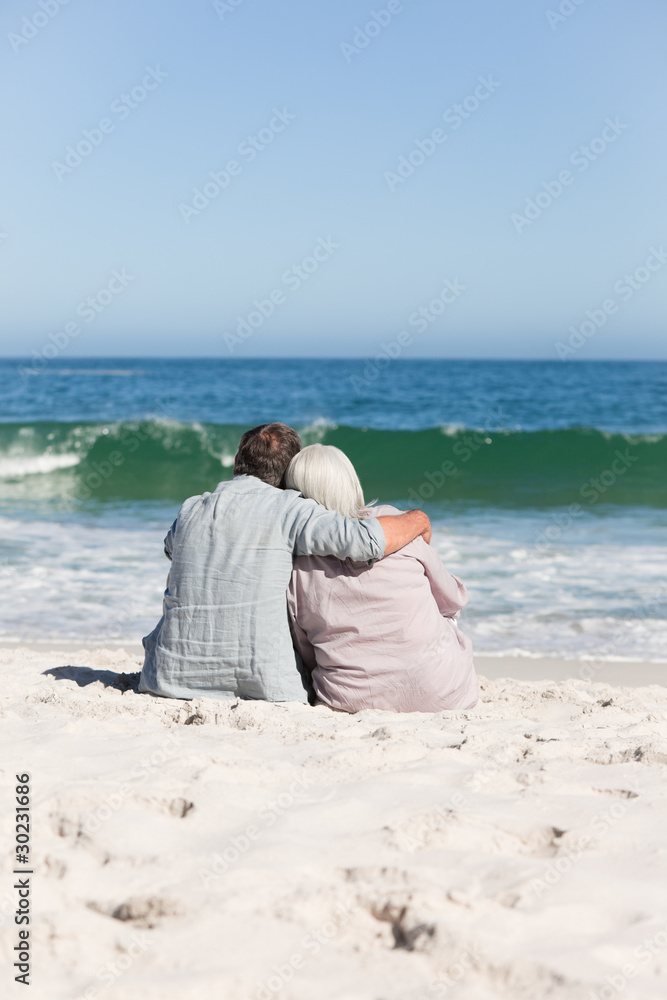 Senior couple sitting on the beach