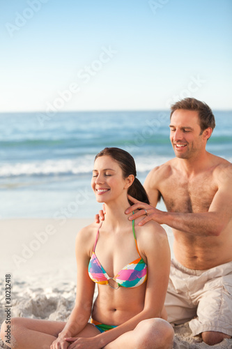 Happy man applying sun cream on his girlfriend's back © WavebreakMediaMicro