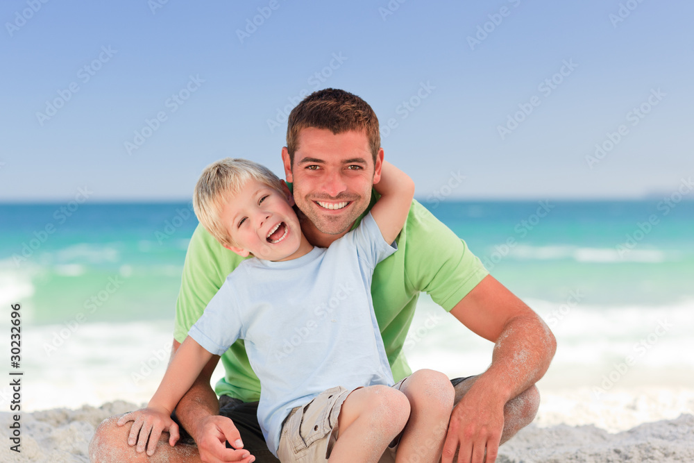Attentive father with his son at the beach Attentive father with his son at the beach