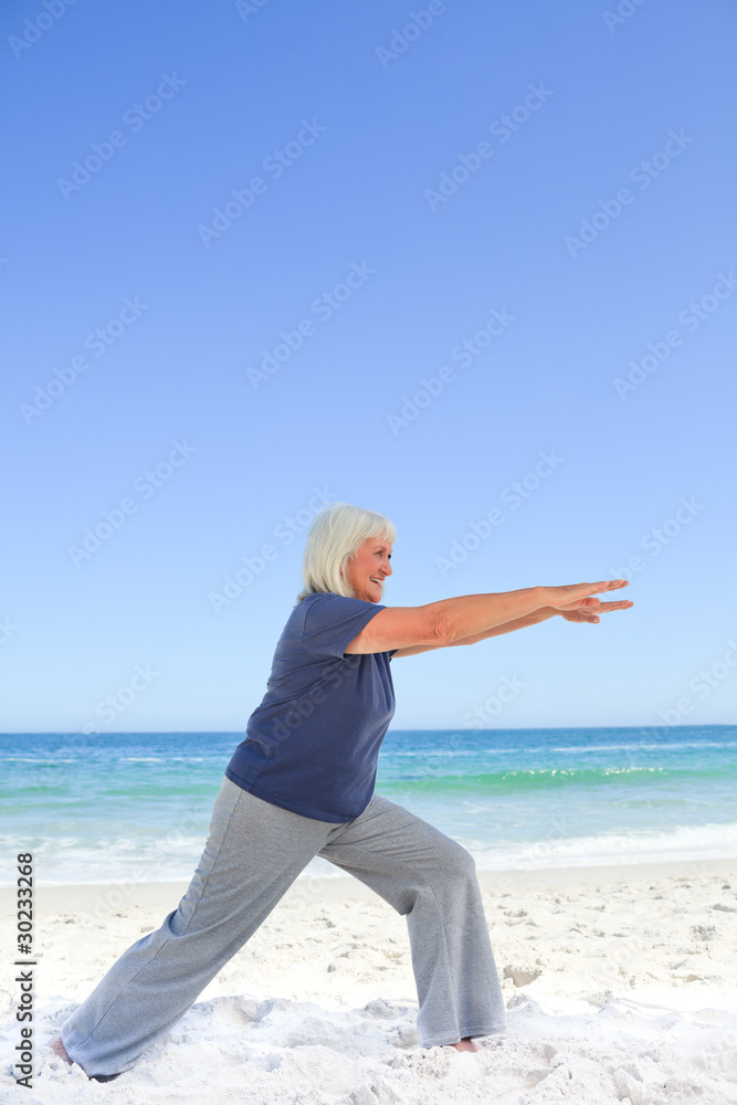 Retired woman doing her stretches Retired woman doing her stretches