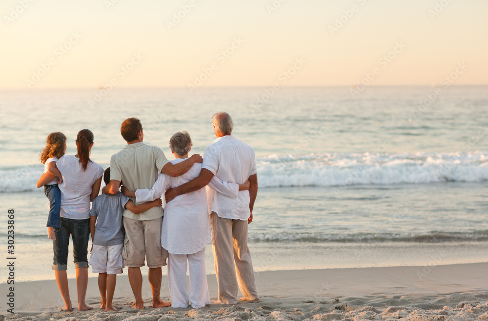 Beautiful family at the beach - obrazy, fototapety, plakaty 