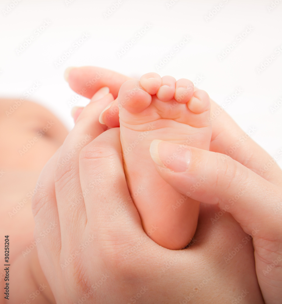 Mother's hands massaging little baby's foot Mother's hands massaging little baby's foot