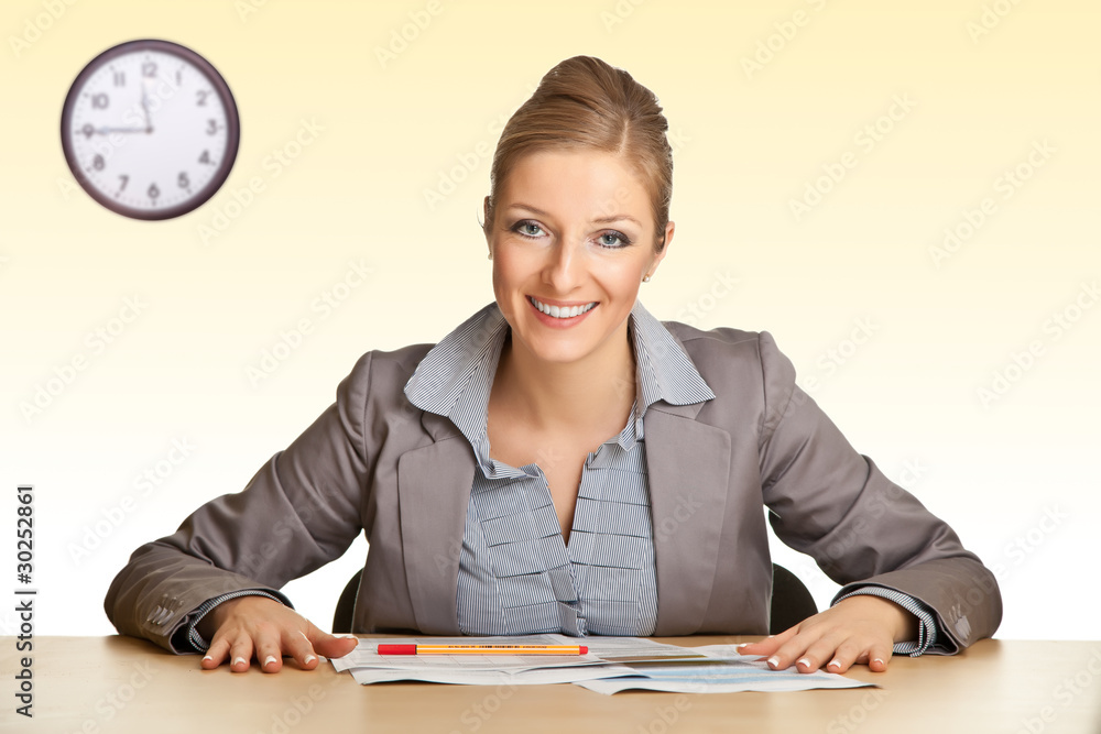 Woman in suit sitting at the desk isolated on white Woman in suit sitting at the desk isolated on white