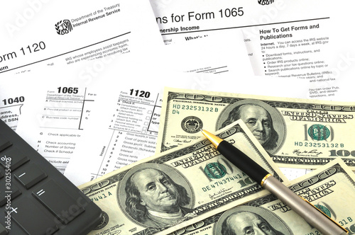 Tax Season. The Concept Image with a calculator, money and tax r