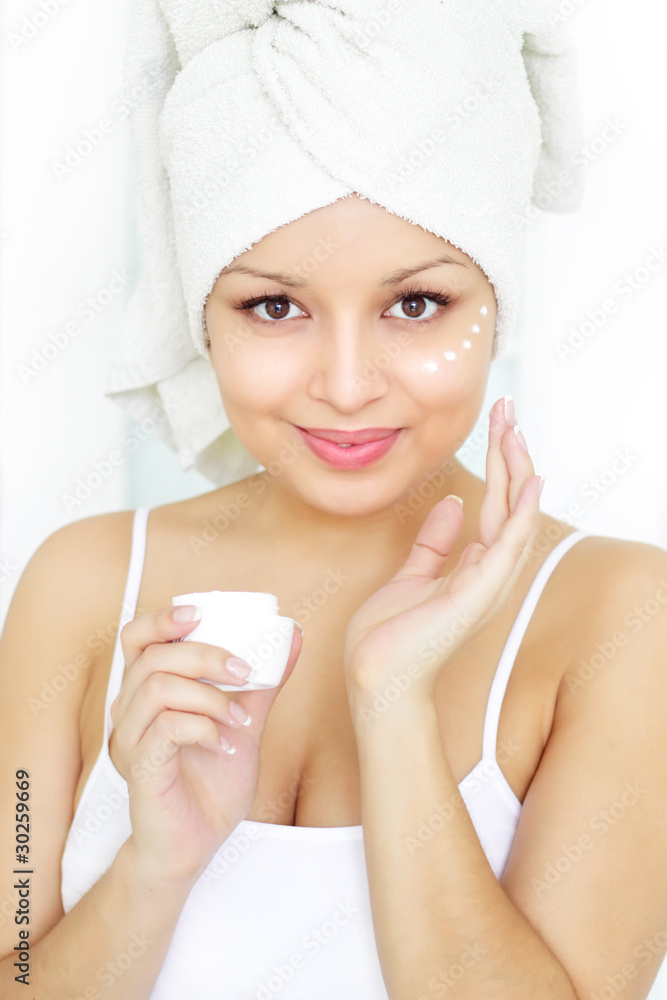 Girl applying cosmetic cream on skin Girl applying cosmetic cream on skin