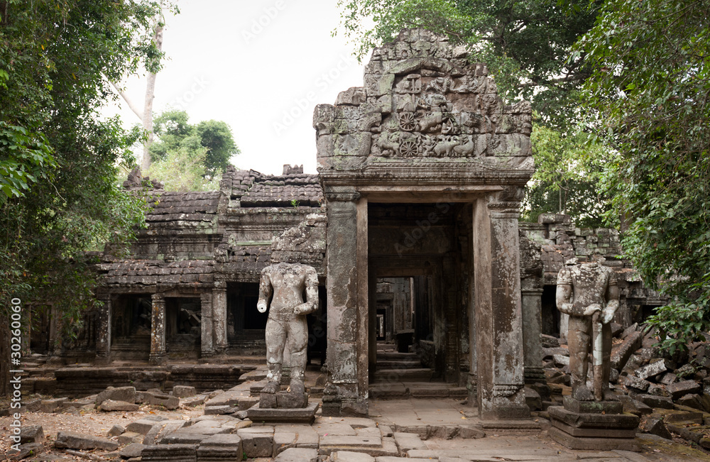 Headless statues gurad the ruined temple of Preah Khan