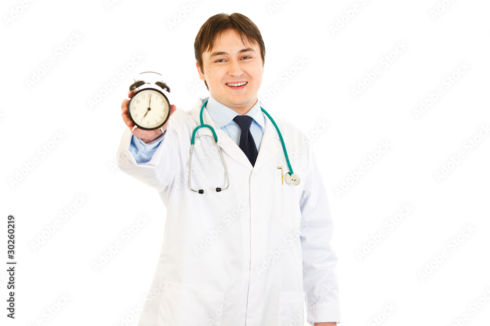 Smiling  medical doctor holding  alarm clock in hand