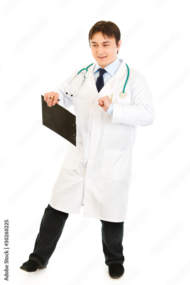Pleased medical doctor with clipboard happy dancing Pleased medical doctor with clipboard happy dancing