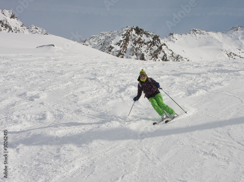 The woman is skiing at a ski resort