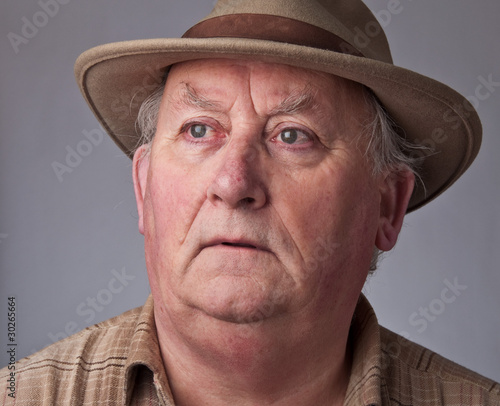 close up senior male wearing a hat