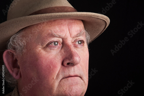 close up senior male wearing a hat